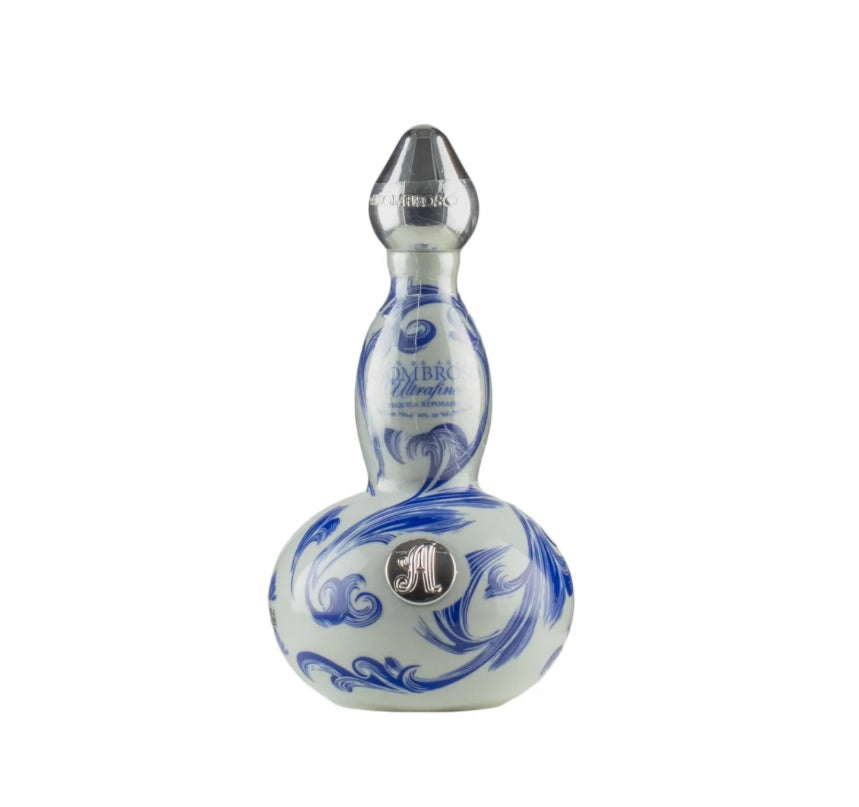 Decorative gourd-shaped ceramic bottle of AsomBroso Eros Reposado Tequila with intricate blue and white swirling floral patterns, a metallic silver cap, and a circular 'A' emblem on the front, displayed against a plain background.