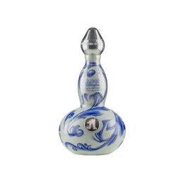 Decorative gourd-shaped ceramic bottle of AsomBroso Eros Reposado Tequila with intricate blue and white swirling floral patterns, a metallic silver cap, and a circular 'A' emblem on the front, displayed against a plain background.