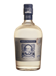 Clear glass bottle of Diplomático Planas Aged White Rum (70cl), featuring a crystal-clear spirit inside. The label is vintage-inspired with a grey-beige background, ornate blue borders, and a central oval portrait of a bearded man (Señor Don Juancho Nieto) in blue tones, surrounded by decorative scrolls. Bold blue text reads "DIPLOMÁTICO" at the top, "PLANAS" below the portrait, and "AGED SIPPING RUM" with additional details like "RON DE VENEZUELA", "EXTRA AÑEJO", and small icons.