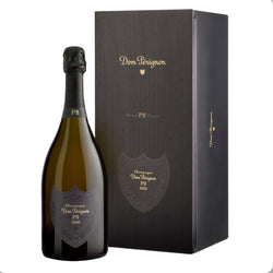 The gift box for Dom Pérignon P2 Vintage 2000, showing the iconic black label with silver typography that denotes the prestigious "Plénitude 2" second life of this mature, complex champagne.