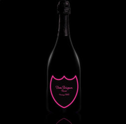 A bottle of Dom Pérignon Rosé Vintage 2008 champagne with a special luminous label that glows in the dark, displayed standing upright. The classic Dom Pérignon branding and vintage year are visible on the front of the bottle.