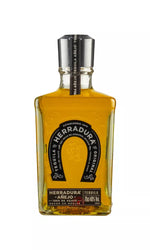 Elegant 70cl bottle of Herradura Añejo Tequila, 40% ABV, with a classic design. This amber tequila, aged 24 months, delivers a smooth, rich flavor with caramel and oak.