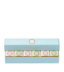 Set of six small boxes with decorative labels in a light blue box on a white background