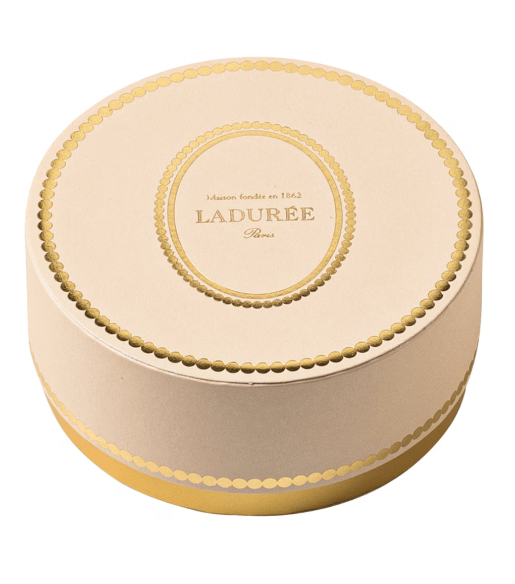 Round Ladère box with gold accents on a white background