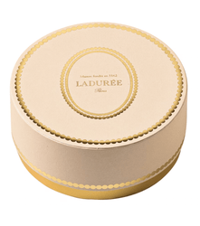 Round Ladère box with gold accents on a white background