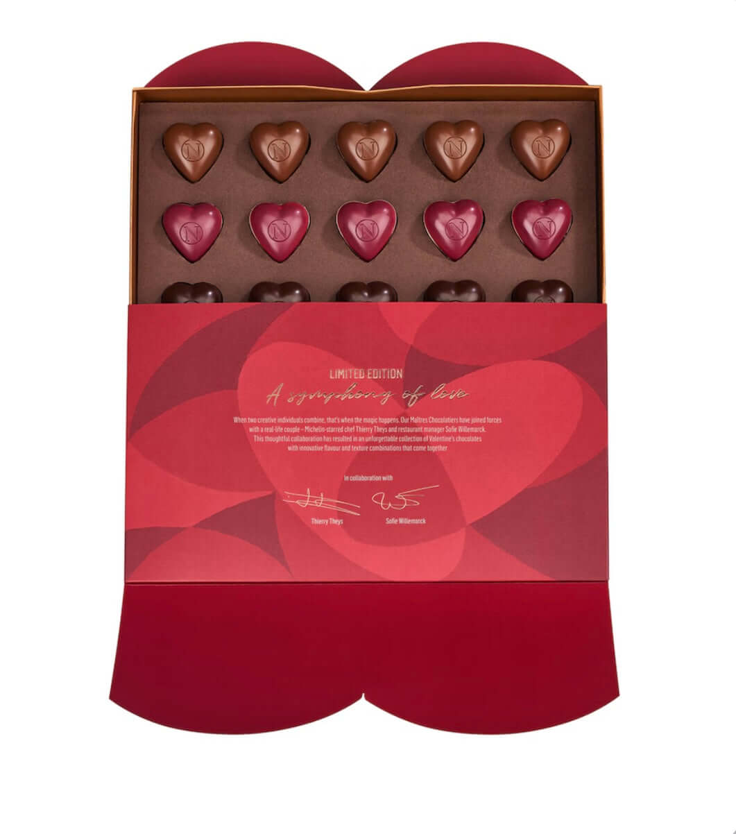 Box of heart-shaped chocolates with a red and gold design on a white background