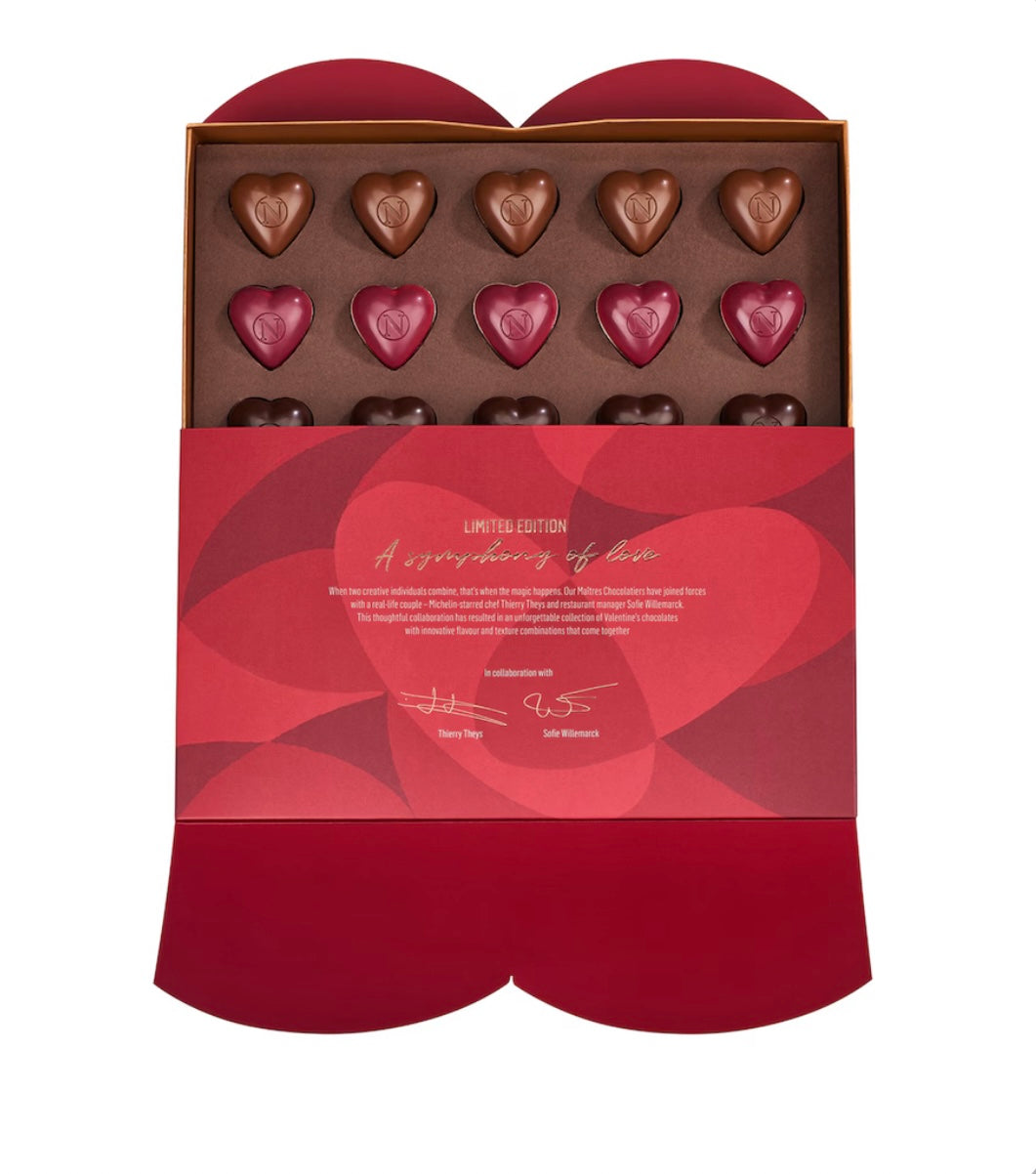 Box of heart-shaped chocolates with a red and gold design on a white background