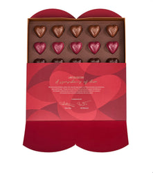 Box of heart-shaped chocolates with a red and gold design on a white background