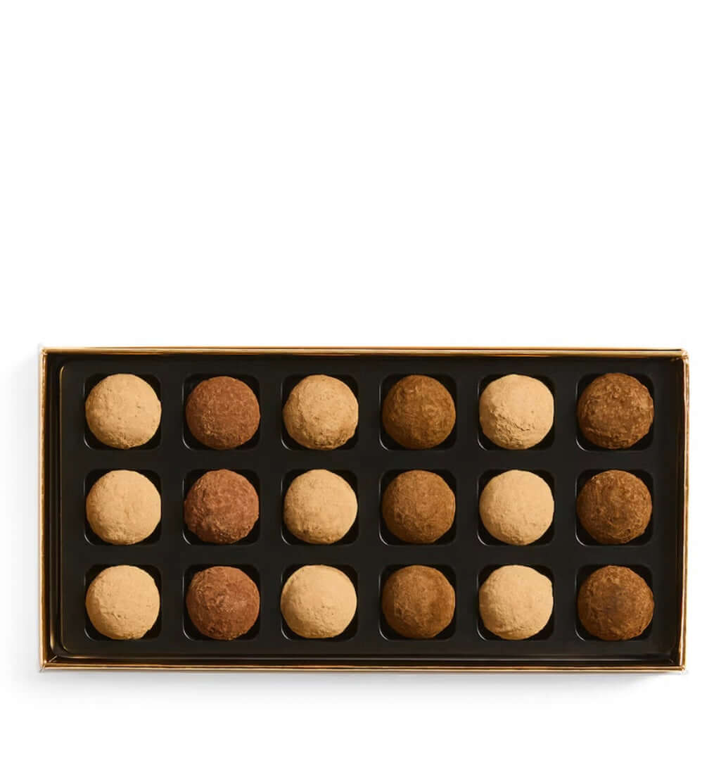 Box of assorted truffles on a white background