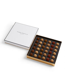 Box of truffles with a white lid displaying 'Pierre Marcolini' branding on a white background.
