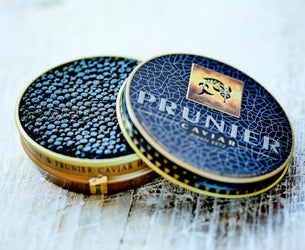 Two containers of Prunner Caviar on a white background