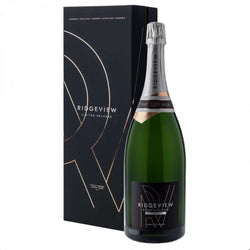 Matte black gift box and large green magnum bottle (150cl) of Ridgeview Blanc de Blancs Limited Release 2009 English sparkling wine. The tall black presentation box features elegant rose-gold geometric line artwork forming an abstract "R" motif, repeated "SUSSEX • ENGLAND" text in gold at the top, "RIDGVIEW LIMITED RELEASE" in white, and "FAMILY OWNED SINCE 1995" in small gold lettering at the base. The bottle has a silver foil capsule, a copper-toned vintage band with "2009" highlighted, and a black label