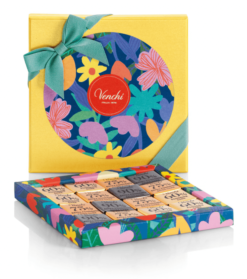 Colorful Venchi chocolate box with floral design and green ribbon on a white background
