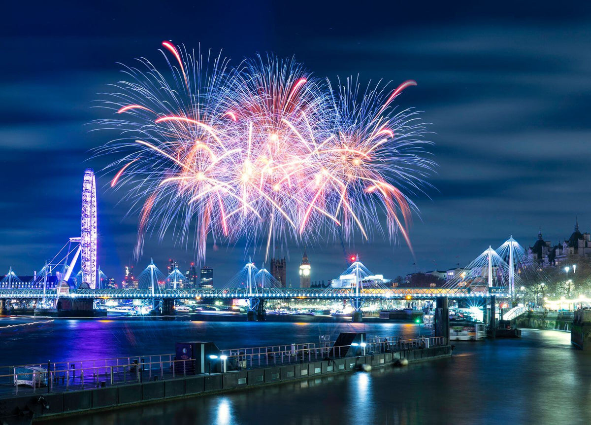 Fireworks lighting up the London skyline at night over the River Thames
