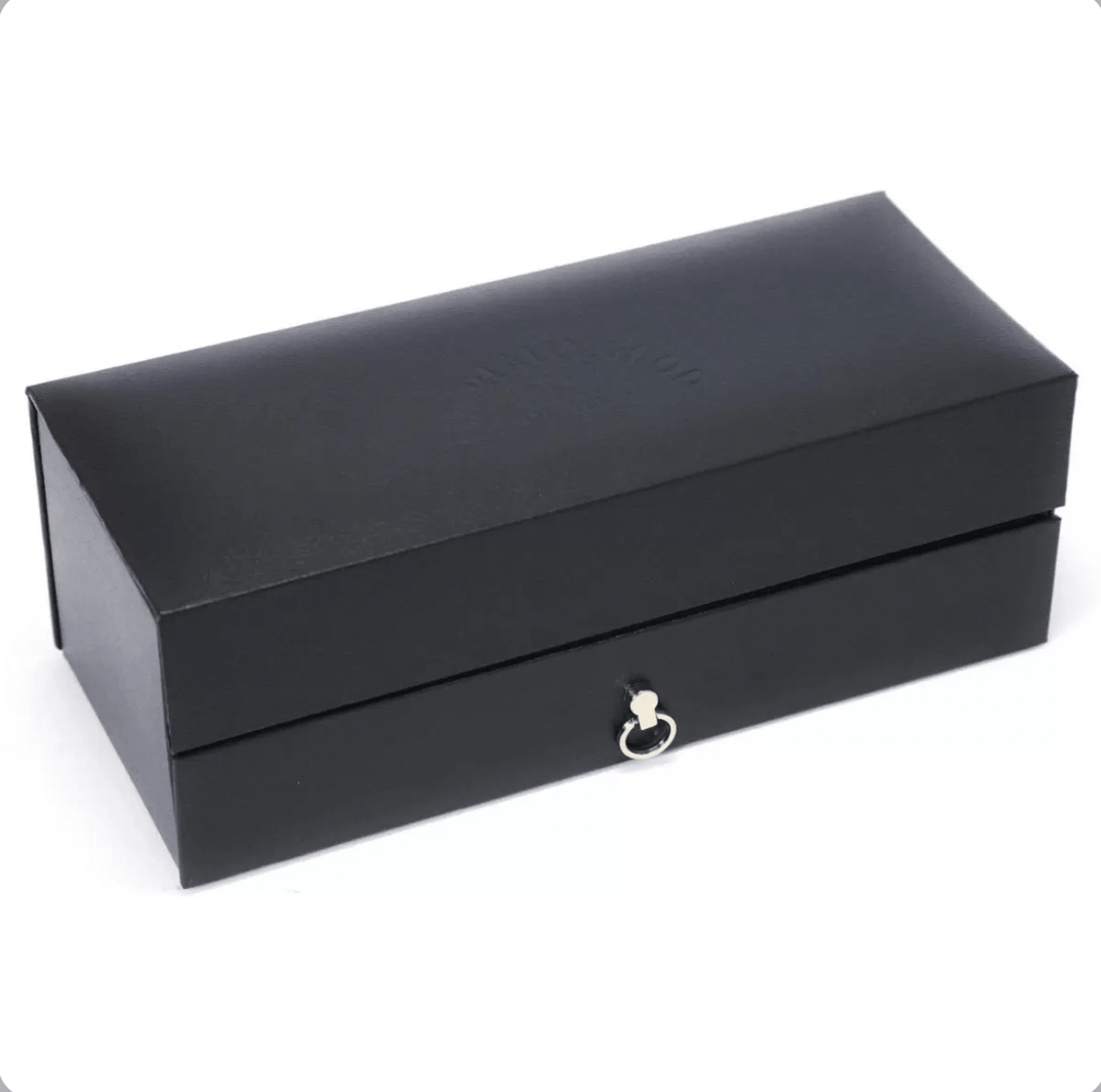 Closed premium black faux leather gift box for Malt Teasers whisky tasting sets. The rectangular, sleek box has a matte black finish with subtle embossed text "MALT TEASERS" or "MALT TEASERS" branding on the lid in faint raised lettering.