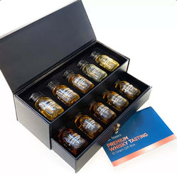 Premium black faux leather gift box open to reveal a 10-dram whisky tasting set from Malt Teasers. The box has a pull-out drawer and foam insert holding ten 3cl miniature bottles with black screw caps and white printed labels identifying the whiskies: Glengoyne 10 Year Old, Tamdhu 12 Year Old, Smokehead, Arran Barrel Reserve, Glenturret Triple Wood, Laphroaig 10 Year Old, Speyburn 15 Year Old, GlenAllachie 12 Year Old, The 6 Isles Blended Malt, and The Antiquary 12 Year Old.