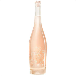 Pale peach-pink bottle of Amie X Organic Rosé 75cl, a premium dry organic rosé from Southern France. The elegant, clear glass bottle features a natural cork closure and a minimalist label with delicate white line-drawn abstract faces forming a heart shape, accompanied by the handwritten-style text "amie" and a small "x" below it. The pale, luminous rosé wine inside glows softly, emphasizing its light, crisp, and fresh appearance against a clean white background.