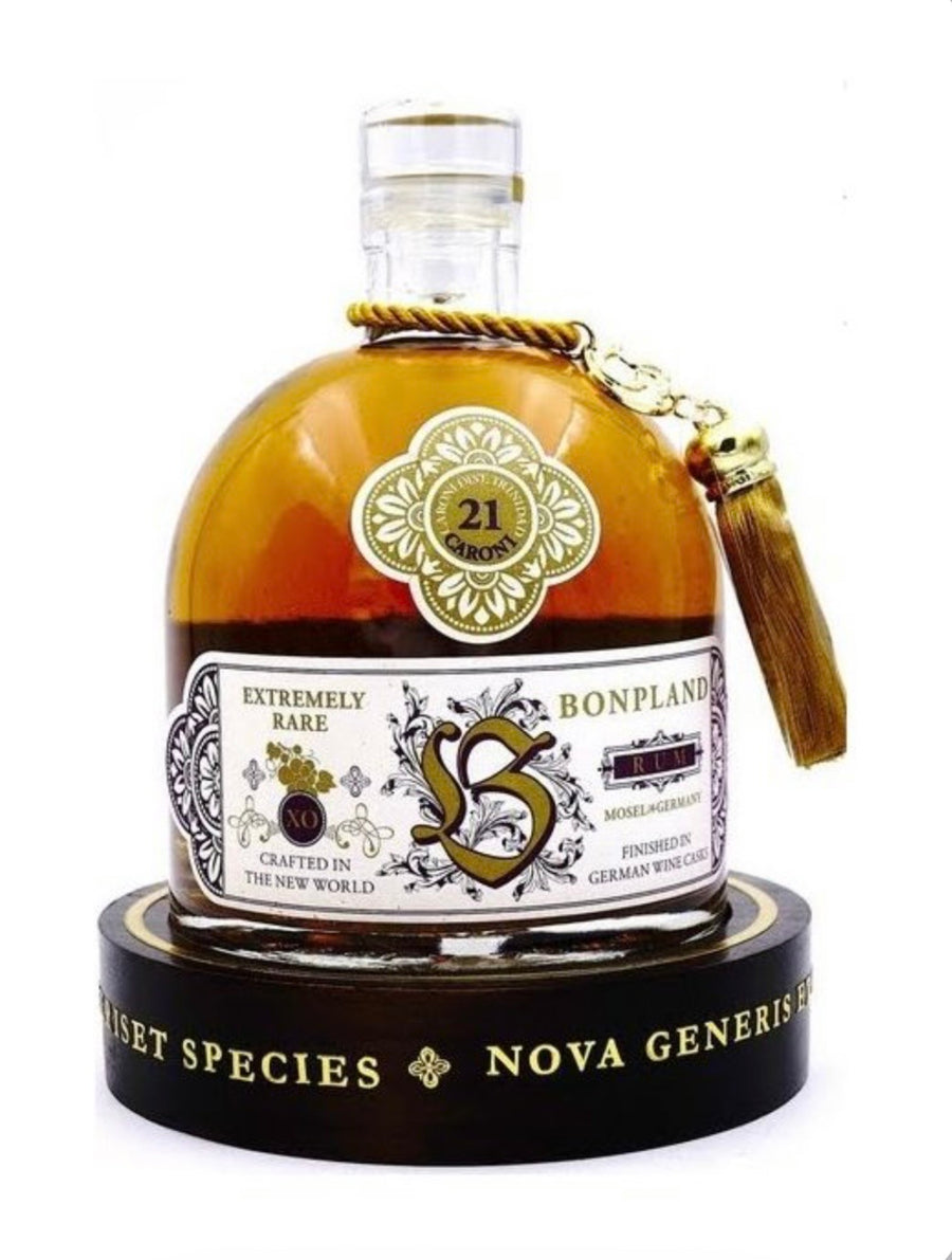 Bottle of Bonpland rum with a decorative label and tassel on a white background