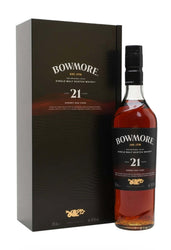 A bottle of Bowmore 21 Year Old single malt Scotch whisky next to its dark brown presentation box, shown on a plain white background.