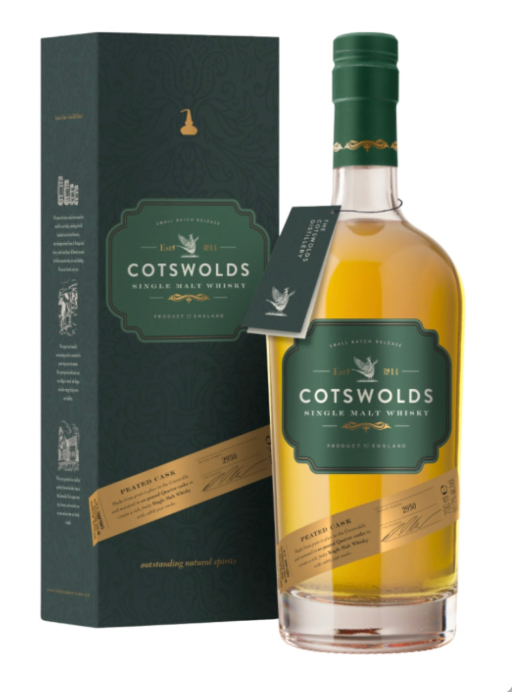 Dark green gift tube and golden-amber whisky bottle of Cotswolds Peated Cask Single Malt Whisky (70cl). The tall cylindrical tube is matte deep green with gold foil accents, featuring ornate text "COTSWOLDS SINGLE MALT WHISKY", "PEATED CASK", "SMALL BATCH RELEASE", "Est. 2014" with a pheasant emblem, and "PRODUCT OF ENGLAND".