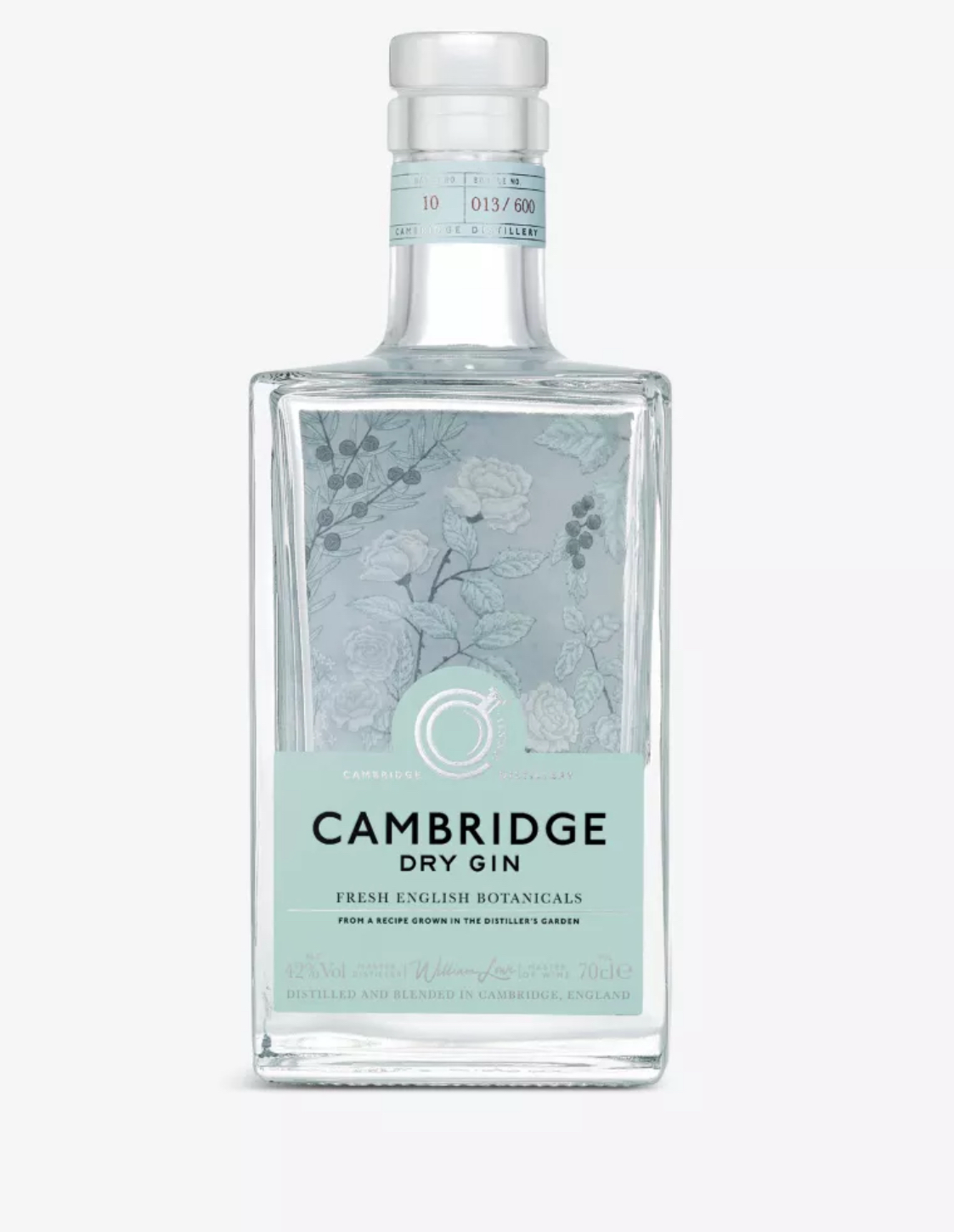 Clear glass square bottle of Cambridge Dry Gin (70cl), filled with crystal-clear gin. The bottle has a clear glass stopper cap and a soft mint-green label with delicate hand-drawn botanical illustrations in white and pale grey: roses, juniper berries, leaves, and stems surrounding the text. The label reads "CAMBRIDGE" at the top in elegant white script, "DRY GIN" in bold capitals below, "FRESH ENGLISH BOTANICALS" and "FROM A RECIPE GROWN IN THE DISTILLER'S GARDEN" in smaller text, "42% Vol." and "70cl e"