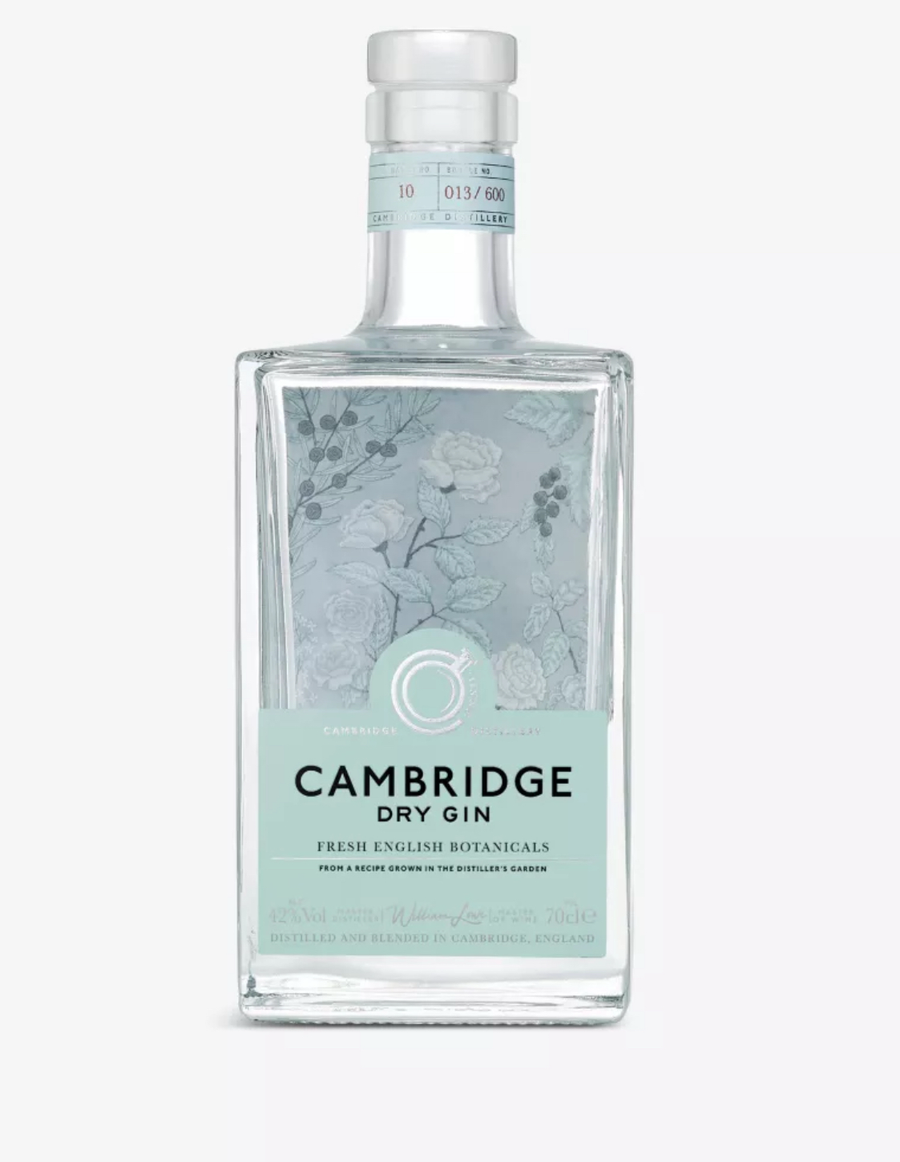 Clear glass square bottle of Cambridge Dry Gin (70cl), filled with crystal-clear gin. The bottle has a clear glass stopper cap and a soft mint-green label with delicate hand-drawn botanical illustrations in white and pale grey: roses, juniper berries, leaves, and stems surrounding the text. The label reads "CAMBRIDGE" at the top in elegant white script, "DRY GIN" in bold capitals below, "FRESH ENGLISH BOTANICALS" and "FROM A RECIPE GROWN IN THE DISTILLER'S GARDEN" in smaller text, "42% Vol." and "70cl e"