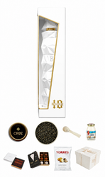 Collection of gourmet items including chocolates, a jar, and a box on a white background