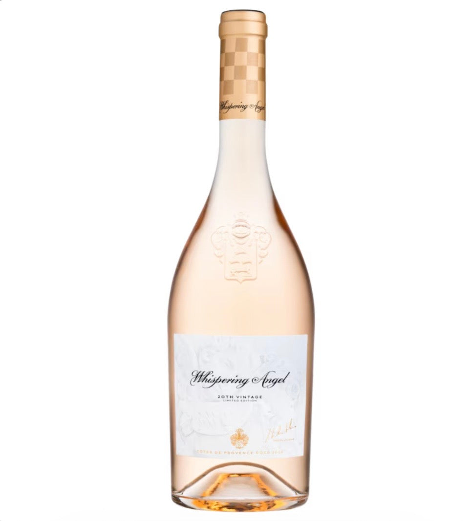 A bottle of Whispering Angel Rosé Champagne Non Alcoholic, featuring a pale pinkish-rose liquid, a white label with elegant black script, and a gold patterned neck foil, set against a plain white background.