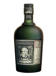 Dark green glass bottle of Diplomático Reserva Exclusiva Rum (70cl), filled with rich amber rum. The label features a vintage-style dark blue and grey design with ornate scrollwork framing a central oval portrait of a bearded man (Señor Don Juancho Nieto) in blue tones. Bold text reads "DIPLOMÁTICO" at the top, "RESERVA EXCLUSIVA" and "RON ANTIGUO" below, with "EXCLUSIVA" in elegant script. A red circular stamp overlay reads "PROPIEDAD PRIVADA" and includes small Venezuelan flag icons and additional fine pr