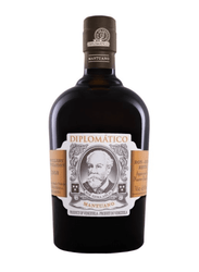 Dark amber rum in a deep brown glass bottle of Diplomático Mantuano Ron Extra Añejo (70cl). The label has a vintage, ornate design with a cream background, gold and brown accents, and a central oval sepia-toned portrait of a bearded man (Don Juancho Nieto) framed by decorative scrolls and filigree. Text includes "DIPLOMÁTICO" at the top in gold, "MANTUANO" below the portrait, "RON EXTRA AÑEJO", "Distillery Foundation 1959", "Aprobado por el Master Blender", and "Product of Venezuela" in multiple languages.