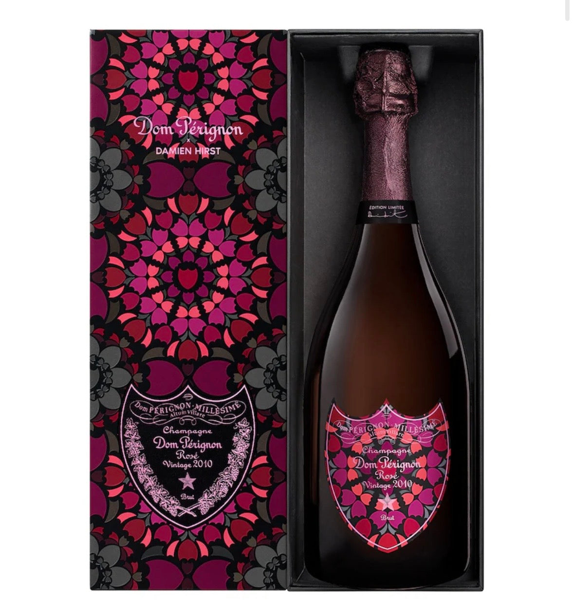 Dom Régnon Daemen Prest champagne bottle presented in a black and Pink gift box with a matching patterned outer sleeve. The bottle and label feature a bold magenta, pink, and purple floral mandala design on a white background.