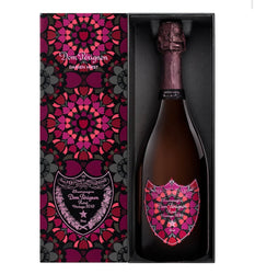 Dom Régnon Daemen Prest champagne bottle presented in a black and Pink gift box with a matching patterned outer sleeve. The bottle and label feature a bold magenta, pink, and purple floral mandala design on a white background.