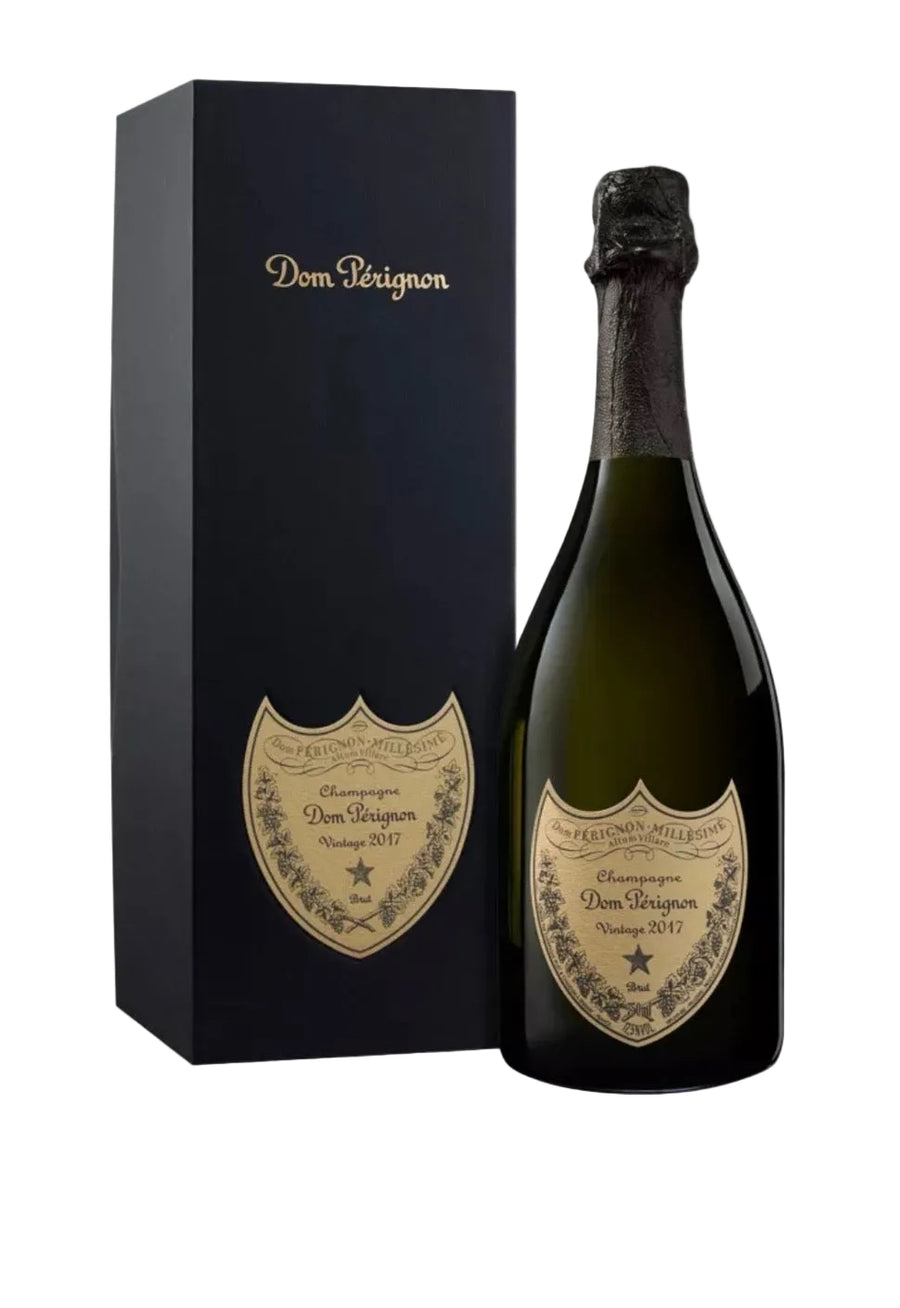 A bottle of Dom Pérignon Champagne next to its black presentation box, both featuring gold foil branding on a light gray background.
