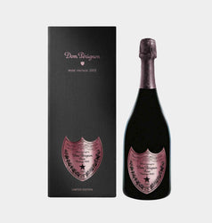 Black gift box and bottle of Dom Pérignon Rosé Vintage 2002 Limited Edition (75cl / 750ml), known as the Jewel Edition or "Dark Jewel". The sleek black presentation box features a pink metallic shield-shaped label with "Dom Pérignon Rosé Vintage 2002" in elegant script, floral vine borders, a star motif, and "LIMITED EDITION" at the base. The bottle has a deep black glass body with a matching pink foil capsule on the neck and a prominent pink shield label mirroring the box design, displaying "Dom Pérignon.