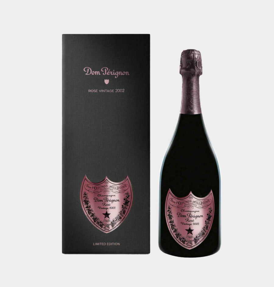 Black gift box and bottle of Dom Pérignon Rosé Vintage 2002 Limited Edition (75cl / 750ml), known as the Jewel Edition or "Dark Jewel". The sleek black presentation box features a pink metallic shield-shaped label with "Dom Pérignon Rosé Vintage 2002" in elegant script, floral vine borders, a star motif, and "LIMITED EDITION" at the base. The bottle has a deep black glass body with a matching pink foil capsule on the neck and a prominent pink shield label mirroring the box design, displaying "Dom Pérignon.