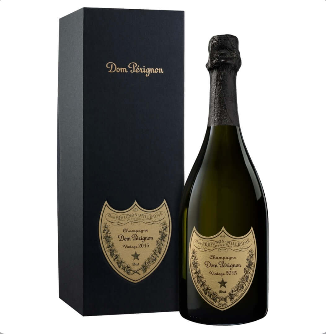 dom-perignon-vintage-2015-champagne-75cl-bottle-next-to-its-sleek-black-gift-box-with-gold-dom-perignon-lettering-showcasing-the-bottle-s-green-glass-black-foil-top-and-gold-shield-label-inscribed-with-champagne-dom-perignon-vintage-2015-brut-and-decorative-vines