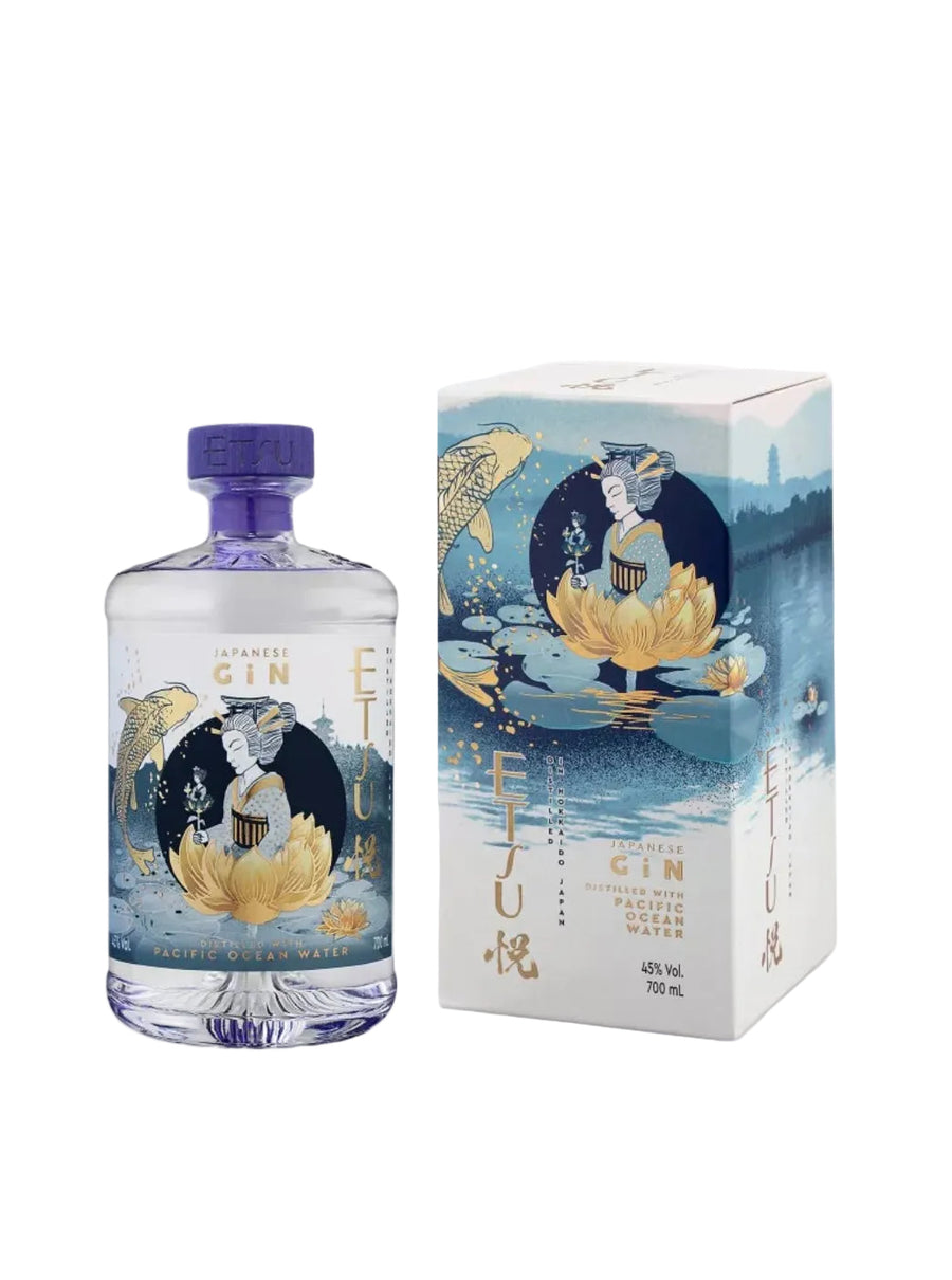 Clear glass bottle of Etsu Japanese Gin Pacific Ocean Water (70cl / 700ml) next to its artistic gift box. The bottle contains crystal-clear gin and features a vibrant, traditional Japanese-inspired label with gold and blue tones: a geisha figure in a kimono sitting on a large lotus flower, holding a branch, surrounded by koi fish, water ripples, a pagoda silhouette, and Mount Fuji in the background. Text reads "ETSU GIN", "PACIFIC OCEAN WATER", "DISTILLED WITH PACIFIC OCEAN WATER", "JAPANESE GIN".