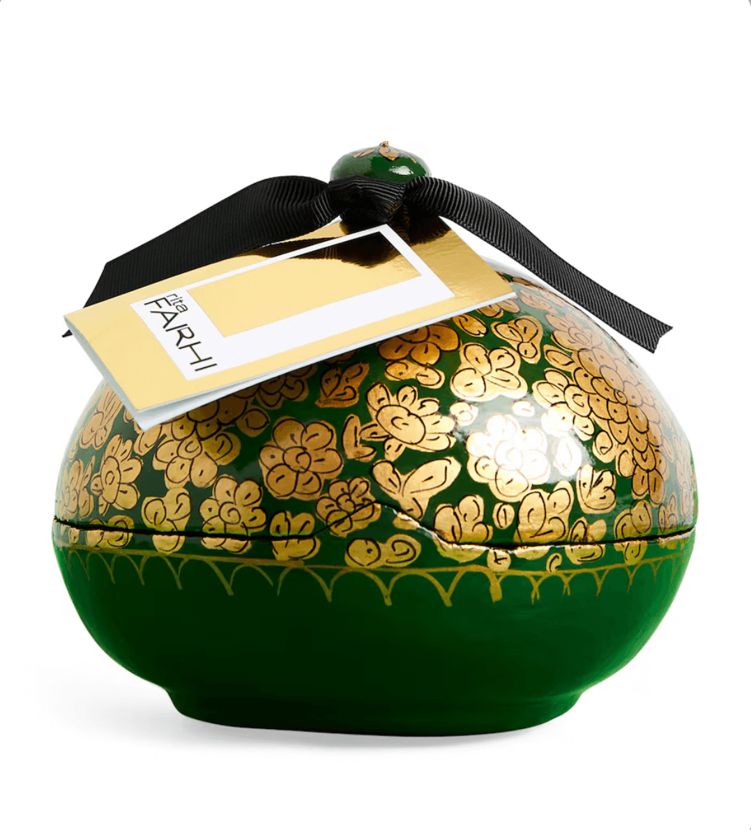 Decorative green container with gold floral patterns and a black ribbon, featuring a 'FARHI' tag.
