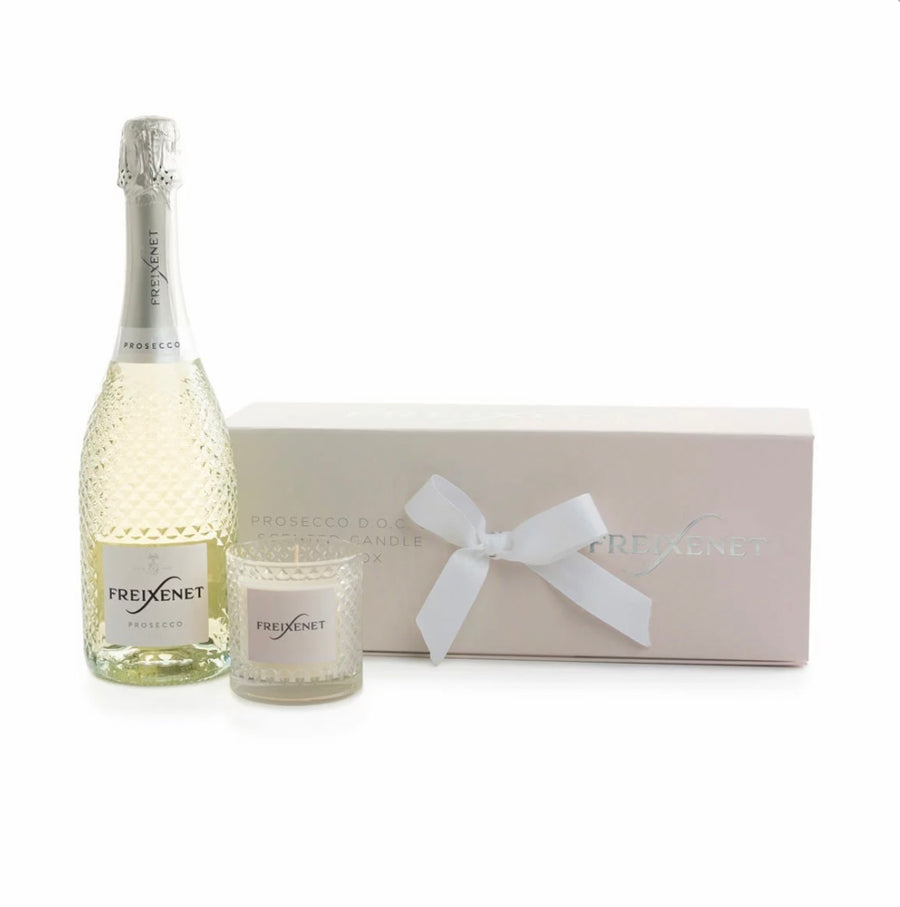 Freixenet bottle and candle with a matching box on a white background
