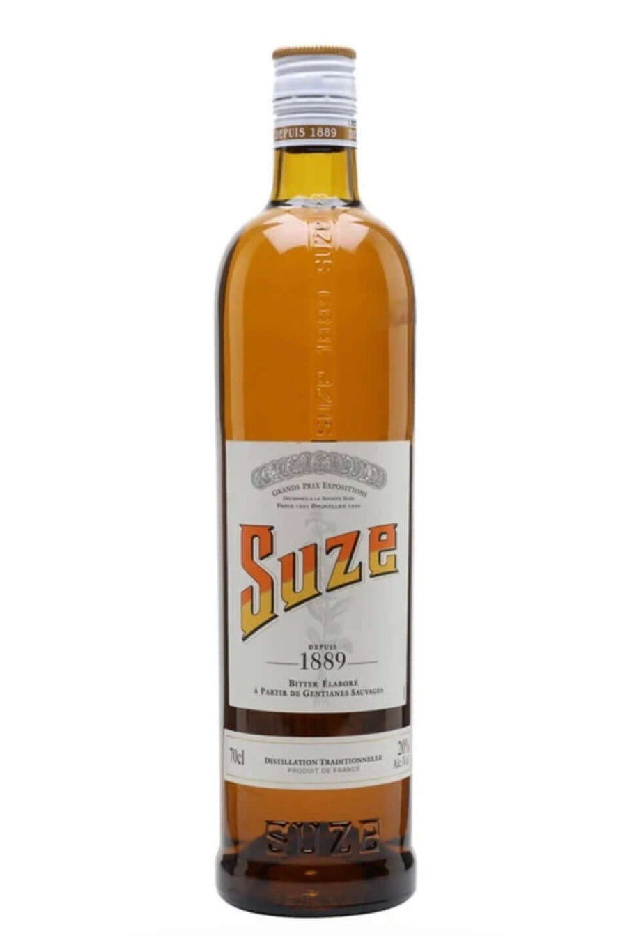 A bottle of Suze cognac liqueur with a white label and silver cap, filled with amber liquid, shown against a plain white background.