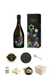 A curated gift set collage on a white background featuring a dark sparkling wine bottle with colorful floral label art, a matching black floral gift box, a round caviar tin, a bowl of black caviar, a small spoon, a jar, pastries, a decorative bowl, and a beige gift box.