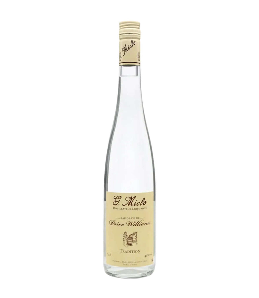 A bottle of St. Miko Peure Williams Tradition spirit distillation liquor, featuring a clear glass bottle, a beige paper label, and a beige foil cap, set against a plain white background.