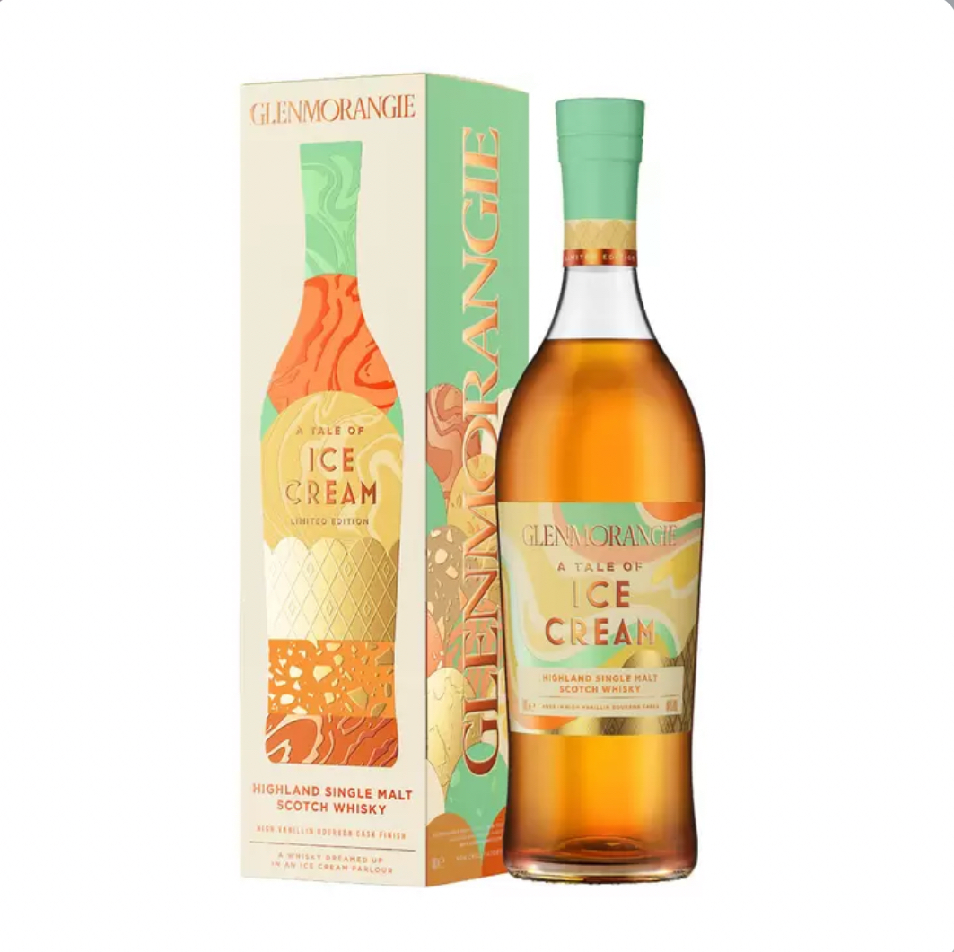 Tall bottle of Glenmorangie A Tale of Ice Cream limited-edition Highland single malt Scotch whisky paired with its vibrant gift tube. The bottle has a warm amber-gold liquid and a light mint-green foil capsule at the top. The label features a colorful, playful design with swirling pastel orange, mint, and yellow tones, ice cream cone patterns, waffle textures, and abstract dessert motifs.