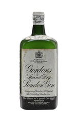 Vintage 1950s bottle of Gordon's Special Dry London Gin (likely 75cl or imperial quart), featuring a classic green glass body with aged, slightly discolored paper label. The label has a cream background with ornate black script reading "Gordon's Special Dry London Gin" in large cursive, "Genuine" and "London" at the top, and the royal appointment text "By Appointment to Her Majesty the Queen Gin Distillers" with a small crown emblem.