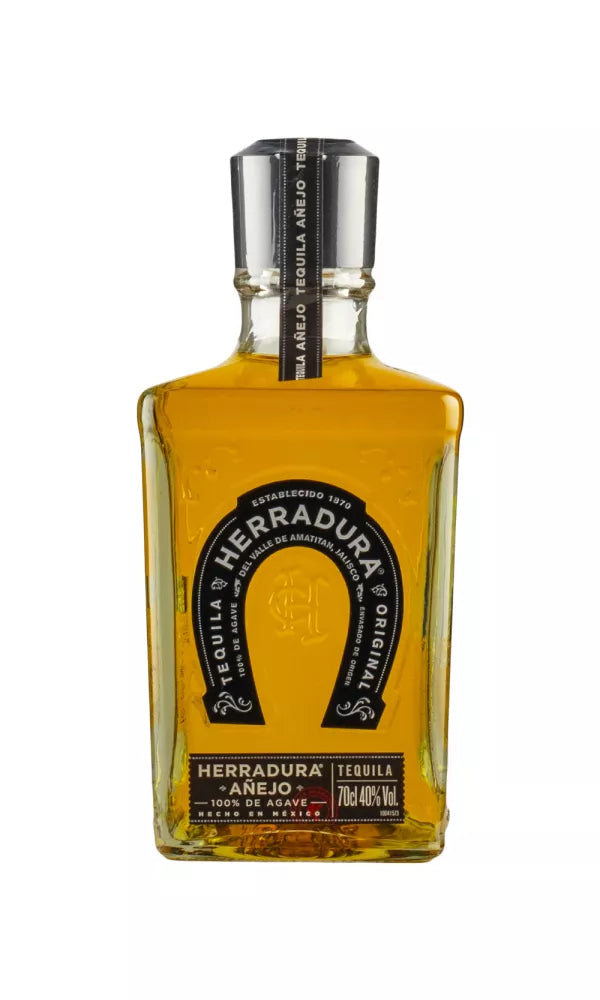 Elegant 70cl bottle of Herradura Añejo Tequila, 40% ABV, with a classic design. This amber tequila, aged 24 months, delivers a smooth, rich flavor with caramel and oak.