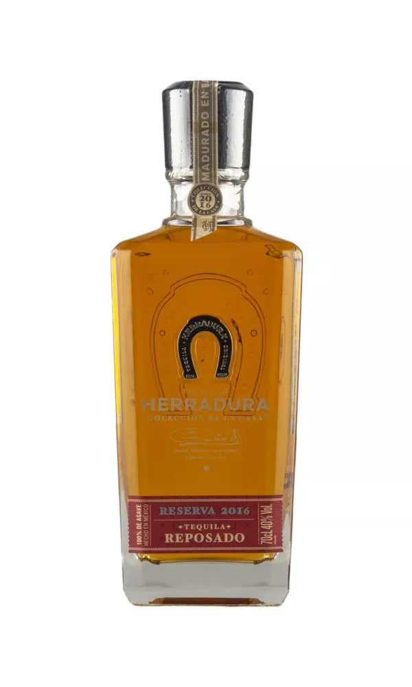 Elegant 70cl bottle of Herradura Port Cask Finish Reposado 2016 Tequila, 40% ABV, with a classic horseshoe logo. This amber tequila blends agave and port-driven fruit notes.