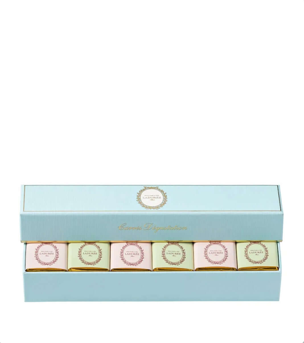 Set of six small boxes with decorative labels in a light blue box on a white background