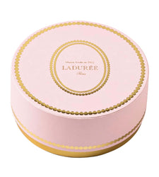 Round pink and gold Ladurée container on a white background
