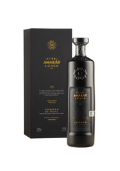Matte black bottle and gift box of Mezcal Amarás Logia Lumbre C2 (700ml), limited-edition ancestral mezcal from rare Lumbre agave, Oaxaca. Sleek black glass with embossed gold sunburst logo, gold metallic label text including "AMARÁS LOGIA", "LUMBRE", "C2 Winter 2023", "Limited Edition", "43% ALC/VOL", and "Rare Agave". Matching black box with gold foil stamping.