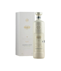 Cream-white bottle and matching white gift box of Mezcal Amarás Logia Madrecuishe C2 (700ml), limited-edition Spring 2022 ancestral mezcal from rare Madrecuishe agave, Oaxaca. Elegant frosted glass with embossed gold sunburst logo, gold metallic label text including "AMARÁS LOGIA", "MADRECUISE", "C2", "Limited Edition Spring 2022", "Joven - 100% Agave Karwinskii", "Ancestral Mezcal", "43% ALC/VOL", and "HECHO EN OAXACA, MÉXICO". Box features gold foil Amarás logo and text.